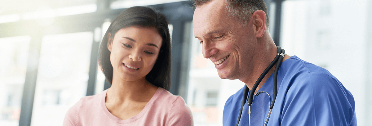 Male-Dr-reviewing-chart-with-female-patient Male doctor reviewing chart with patient