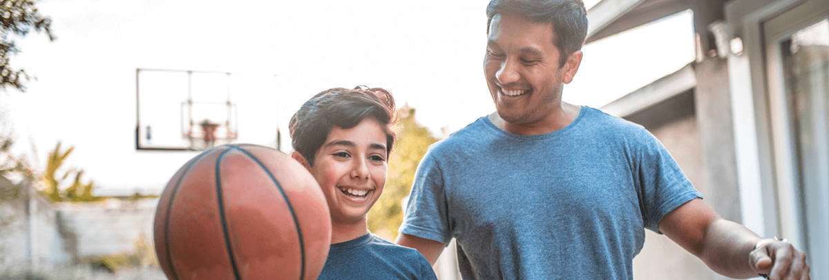 father-and-young-son-playing-basketball Father and young son playing basketball